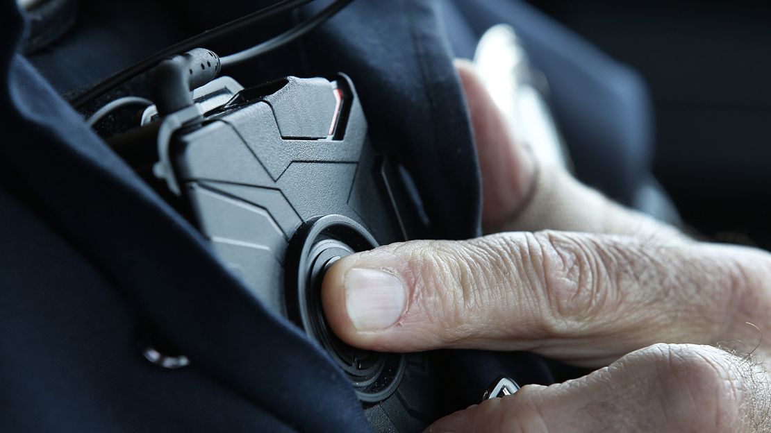 A West Valley City patrol officer in Utah starts a body camera recording by pressing a button on his chest.