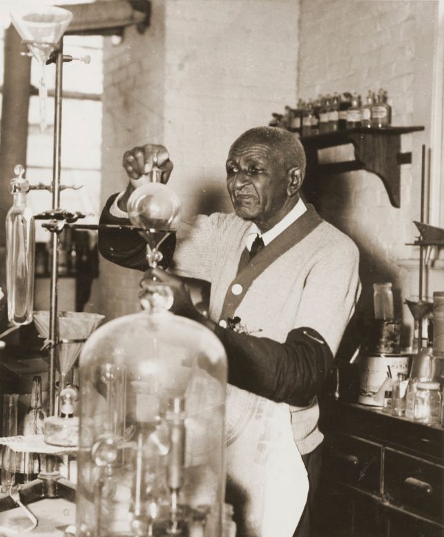 Natural scientist and inventor George Washington Carver working with chemistry equipment in his laboratory at Tuskegee University.