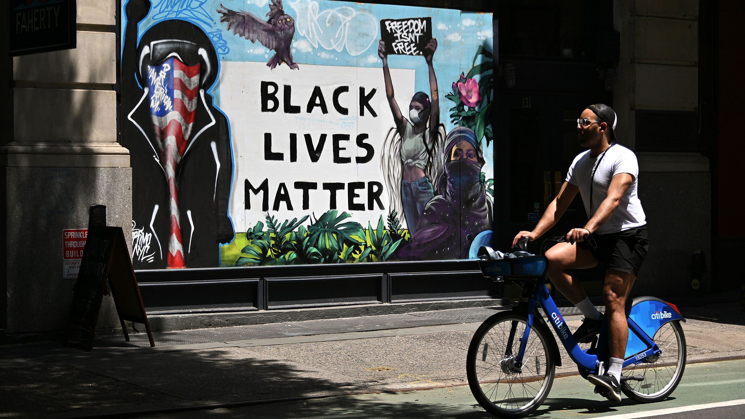 A cyclist rides past a Black Lives Matter in New York City's SoHo neighborhood on June 19.