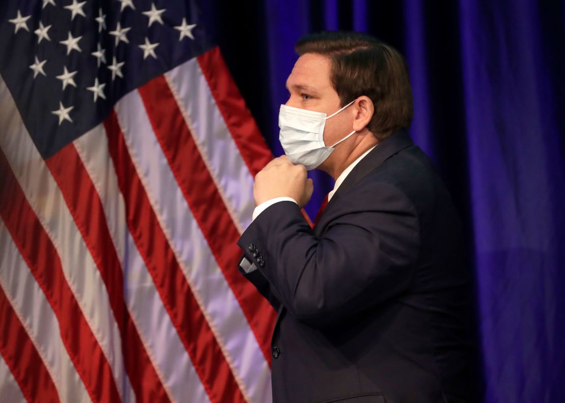 Florida governor and staunch Trump ally Ron DeSantis has resisted mandating masks for all, but he did don his own mask as he left a news conference on June 19 at Florida International University in Miami.