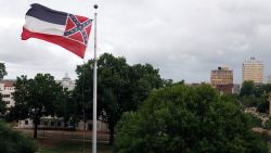 A Mississippi state flag flies outside the Capitol in Jackson, Miss., Thursday, June 25, 2020. Athletic coaches and their staffs from the state's public universities held a joint news conference and called for a change in the Mississippi state flag. Additionally, several head coaches met with both the lieutenant governor and Speaker Philip Gunn, as well as their lawmakers, to lobby for the change. The current flag has in the canton portion of the banner the design of the Civil War-era Confederate battle flag, that has been the center of a long-simmering debate about its removal or replacement. (AP Photo/Rogelio V. Solis)