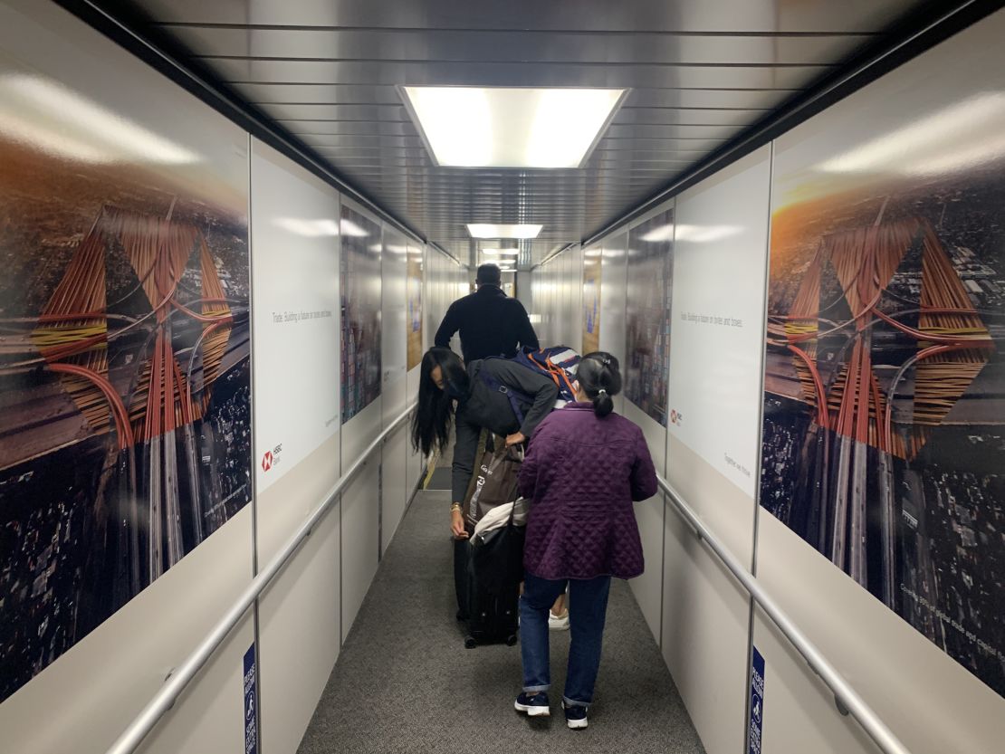 A solitary journey ends in a crowded jet way, Gate 37 at JFK Terminal 4.