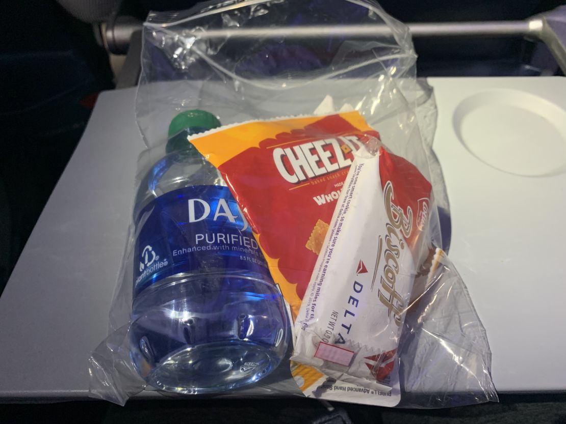 Snack pack with Cheez-Its, water, Biscoff cookies and Purell.
