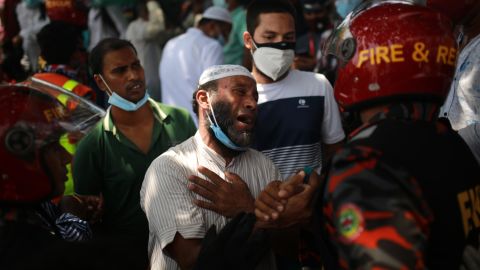 A relative of a victim reacts after rescuers recovered the bodies of victims.