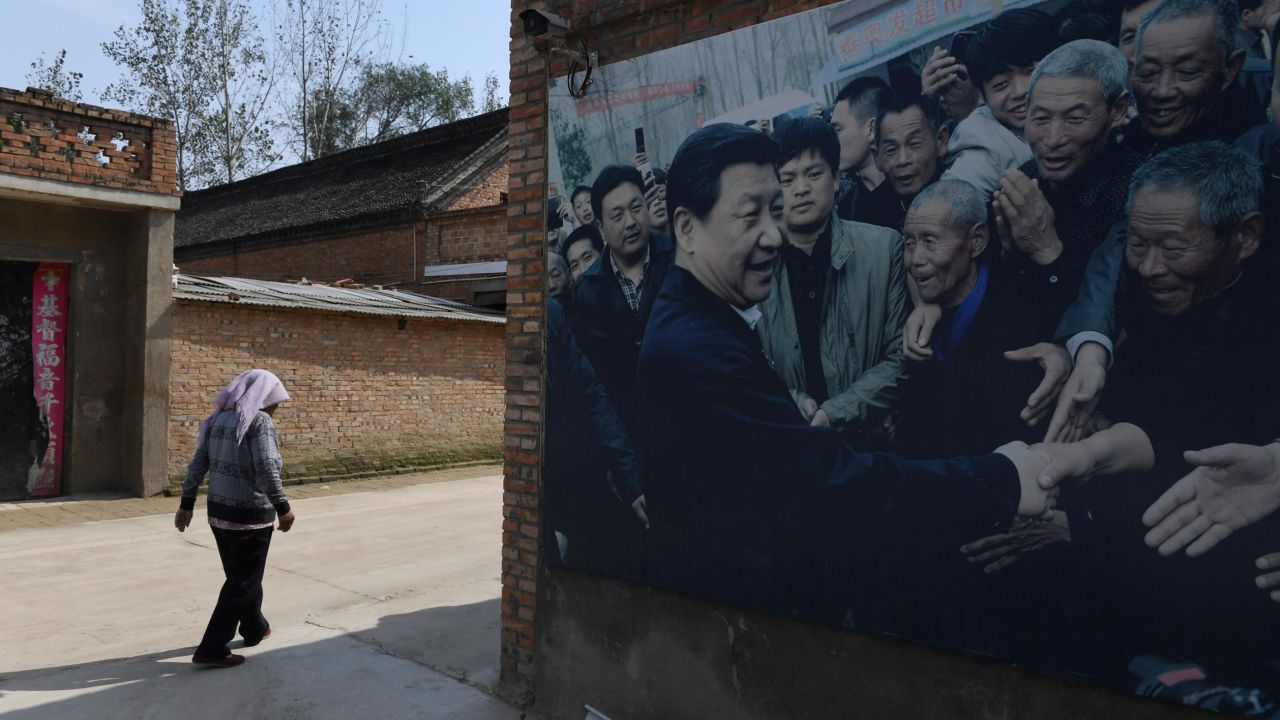 This photo taken in September 2017 shows A billboard featuring a photo of China's President Xi Jinping visiting residents in Zhangzhuang village in Lankao in China's central Henan province. 