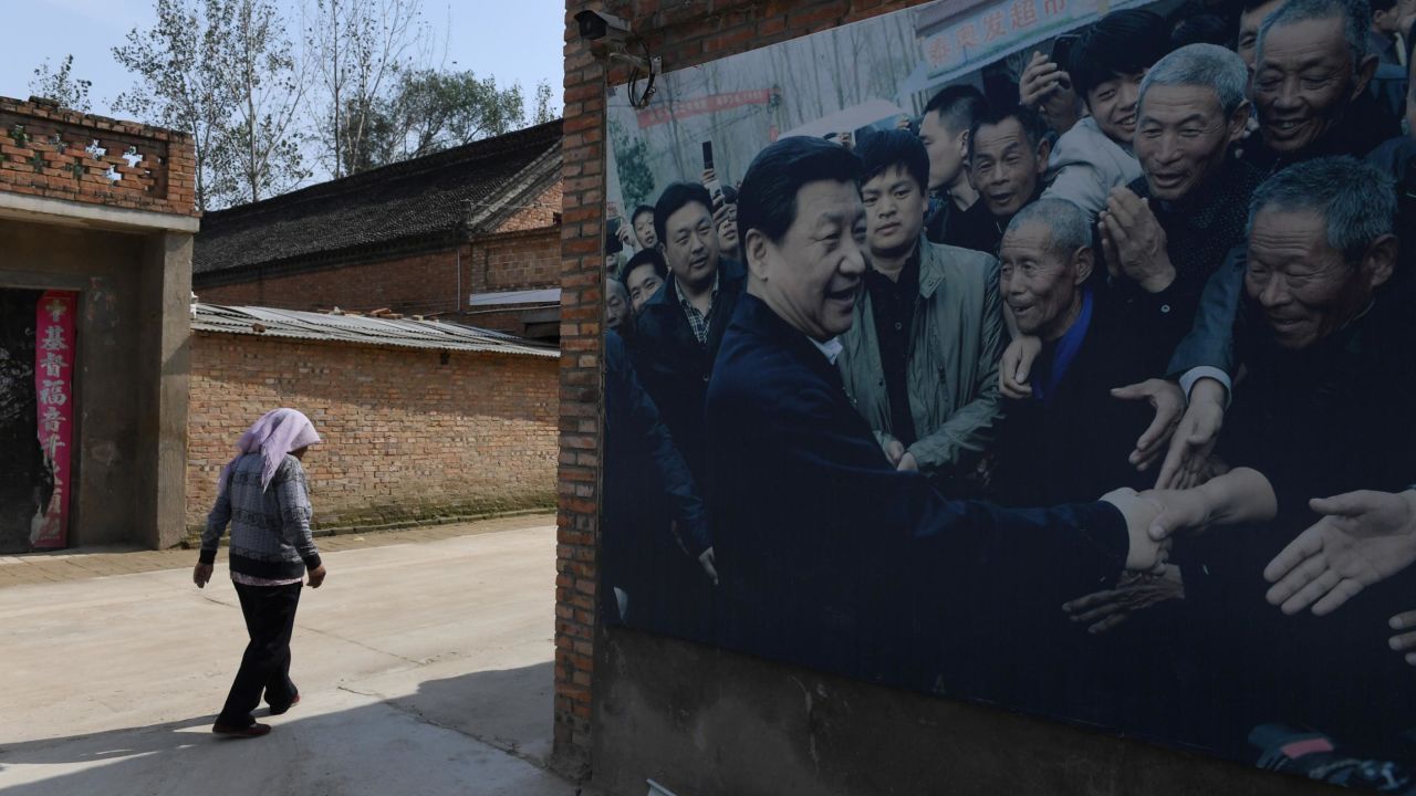 This photo taken in September 2017 shows A billboard featuring a photo of China's President Xi Jinping visiting residents in Zhangzhuang village in Lankao in China's central Henan province.