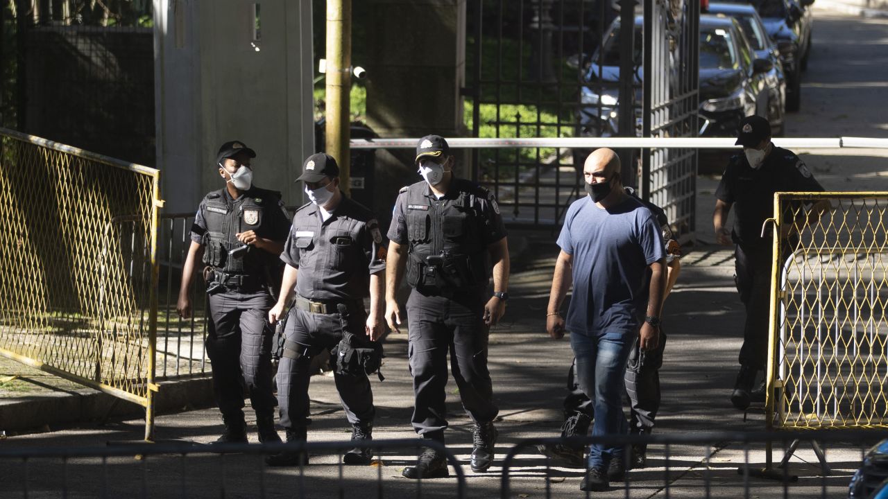 Military police walk outside the official residence of Rio de Janeiro Gov. Wilson Witzel on May 26 after a raid by Federal Police as part of an investigation into the alleged embezzlement of public resources.