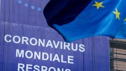An European Union (EU) flag flutters in front of a newly hung banner that reads "Coronavirus Global Response" in front of The EU Commission building in Brussels, on May 6, 2020. - The EU forecast on May 5, 2020,  that the eurozone economy would contract by a staggering 7.7 percent in 2020, warning the wreckage from the coronavirus outbreak could endanger the single currency. Calling it a "recession of historic proportions", the EU executive said the 19-member single currency zone would rebound by 6.3 percent in 2021, but in a recovery that would be felt unevenly across the continent. (Photo by Kenzo TRIBOUILLARD / AFP) (Photo by KENZO TRIBOUILLARD/AFP via Getty Images)