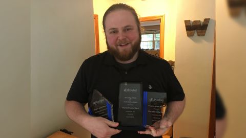 Ward with the awards he received at the commencement ceremony for his 4.0 GPA. 