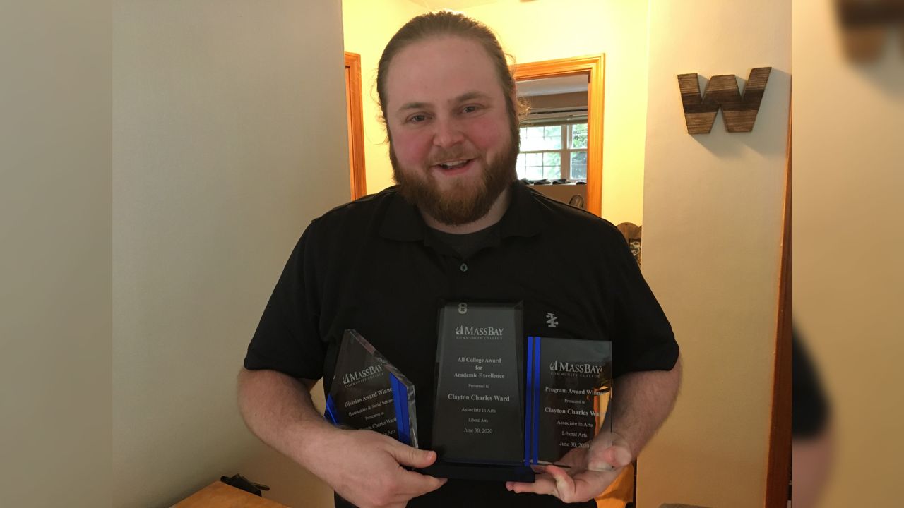 Ward with the awards he received at the commencement ceremony for his 4.0 GPA.