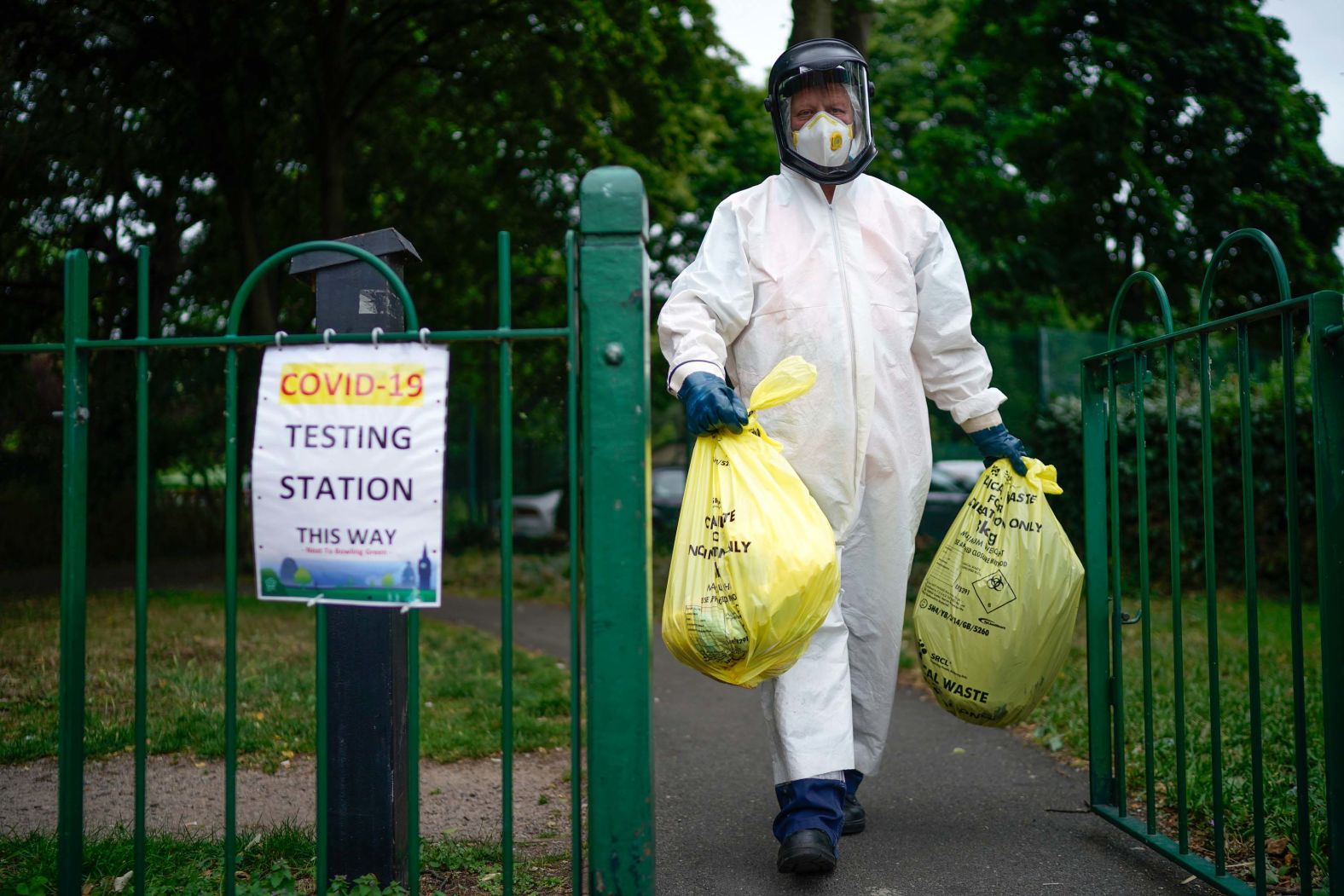 A city council worker carries trash from a coronavirus testing center in Leicester, England, on June 29. Schools and stores in the city of Leicester were closing again, with <a href="index.php?page=&url=https%3A%2F%2Fwww.cnn.com%2Fworld%2Flive-news%2Fcoronavirus-pandemic-06-30-20-intl%2Fh_64a41a8d1320704c23448d991d0492d2" target="_blank">some restrictions being reimposed</a> because of its high infection rate.