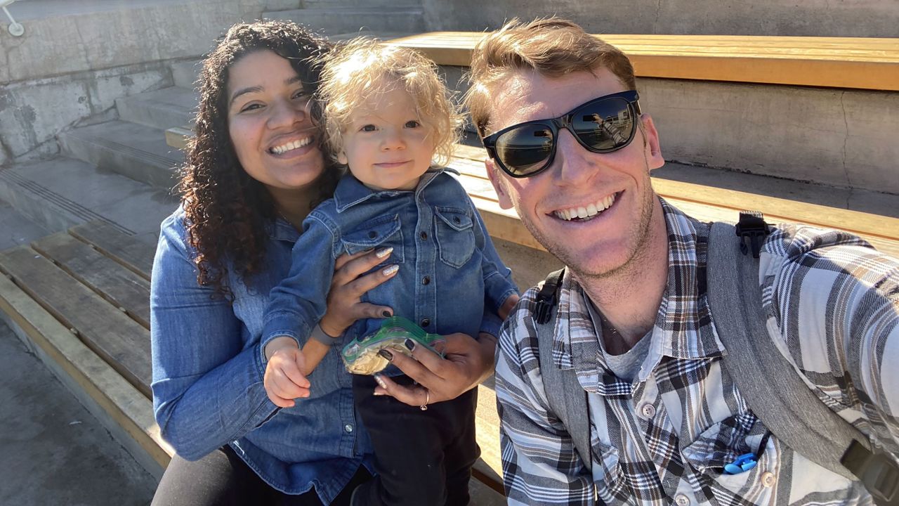 Mariana Austin (left) of Castro Valley, California, shown here with her son and husband, Gabriel Austin, is able to stay home with Axel, age 2, thanks to a paid leave program passed by the US Congress in March. 