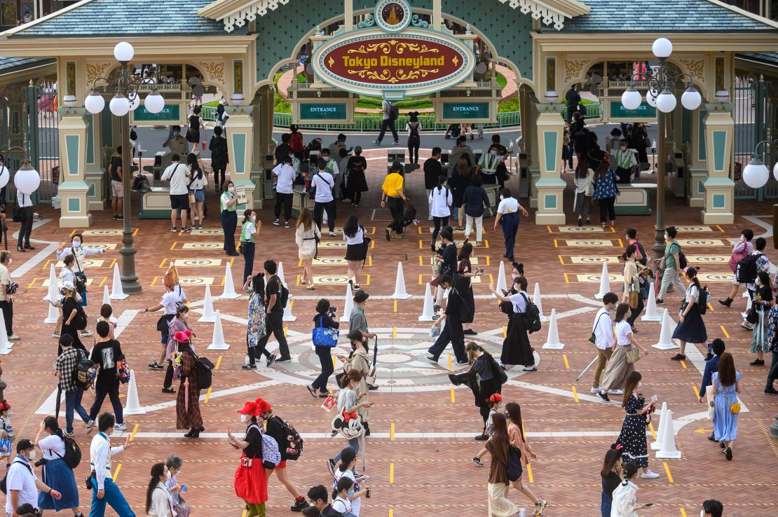 Guests wait in a socially-distant line to get into Tokyo Disneyland on opening day.