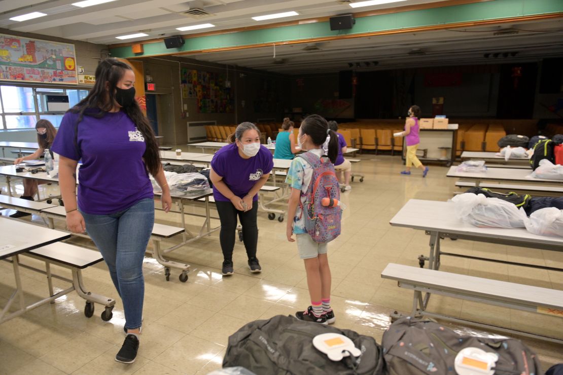 Teachers hand out graduation gifts at a New York City elementary school, not knowing when they will be back.