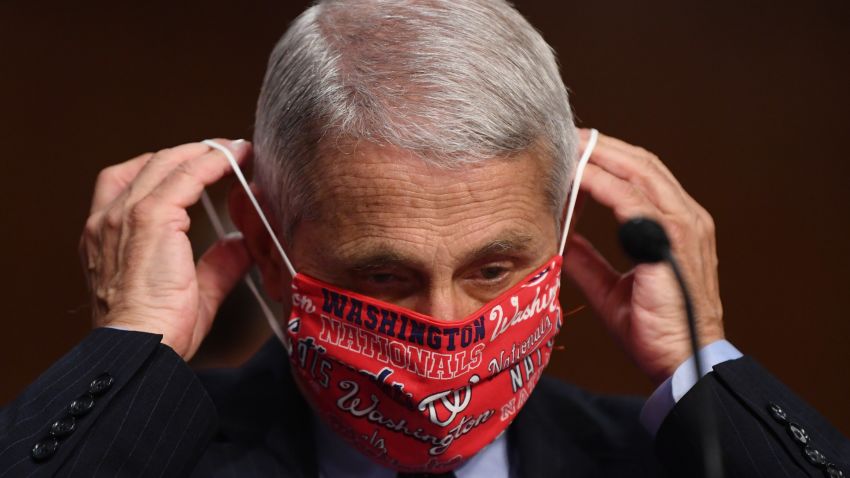 Dr. Anthony Fauci lowers his face mask as he prepares to testify before the Senate Health, Education, Labor and Pensions (HELP) Committee on Capitol Hill.