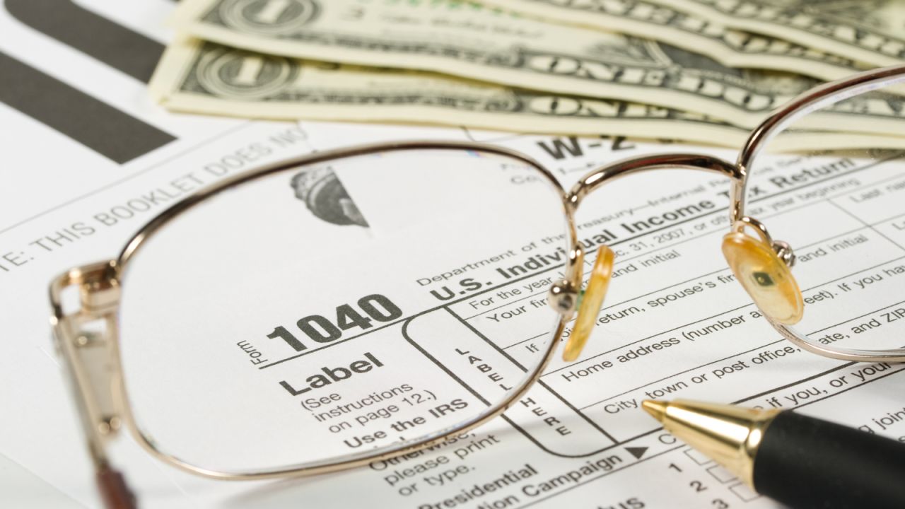 underscored tax form 1040 with glasses