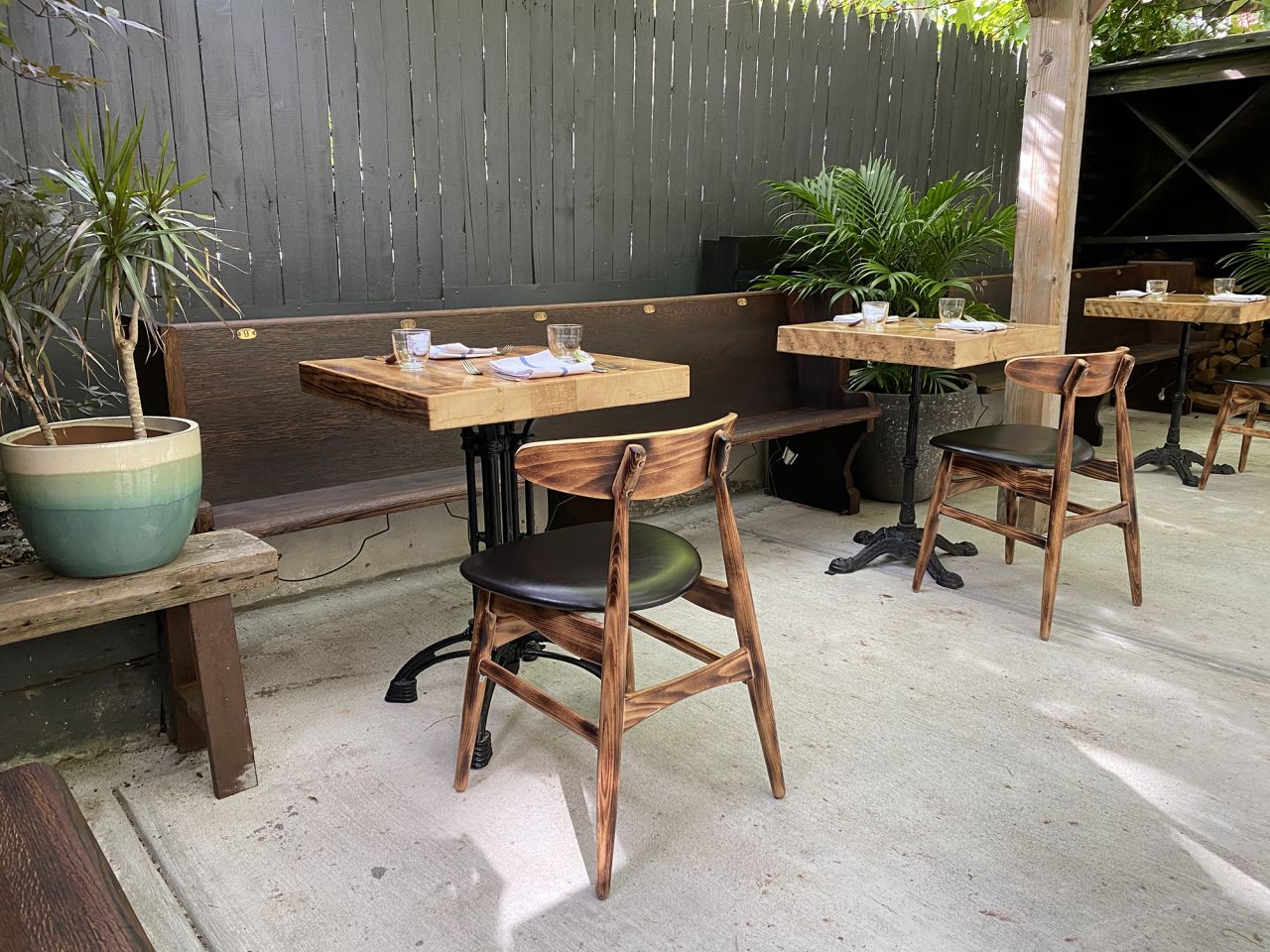 Claro's backyard is a lush space with socially distanced tables.