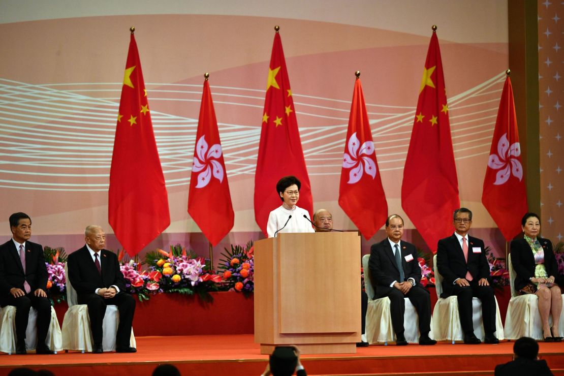 Hong Kong's Chief Executive Carrie Lam (C) speaks to guests following a flag-raising ceremony to mark China's National Day celebrations early morning in Hong Kong on July 1, 2020.