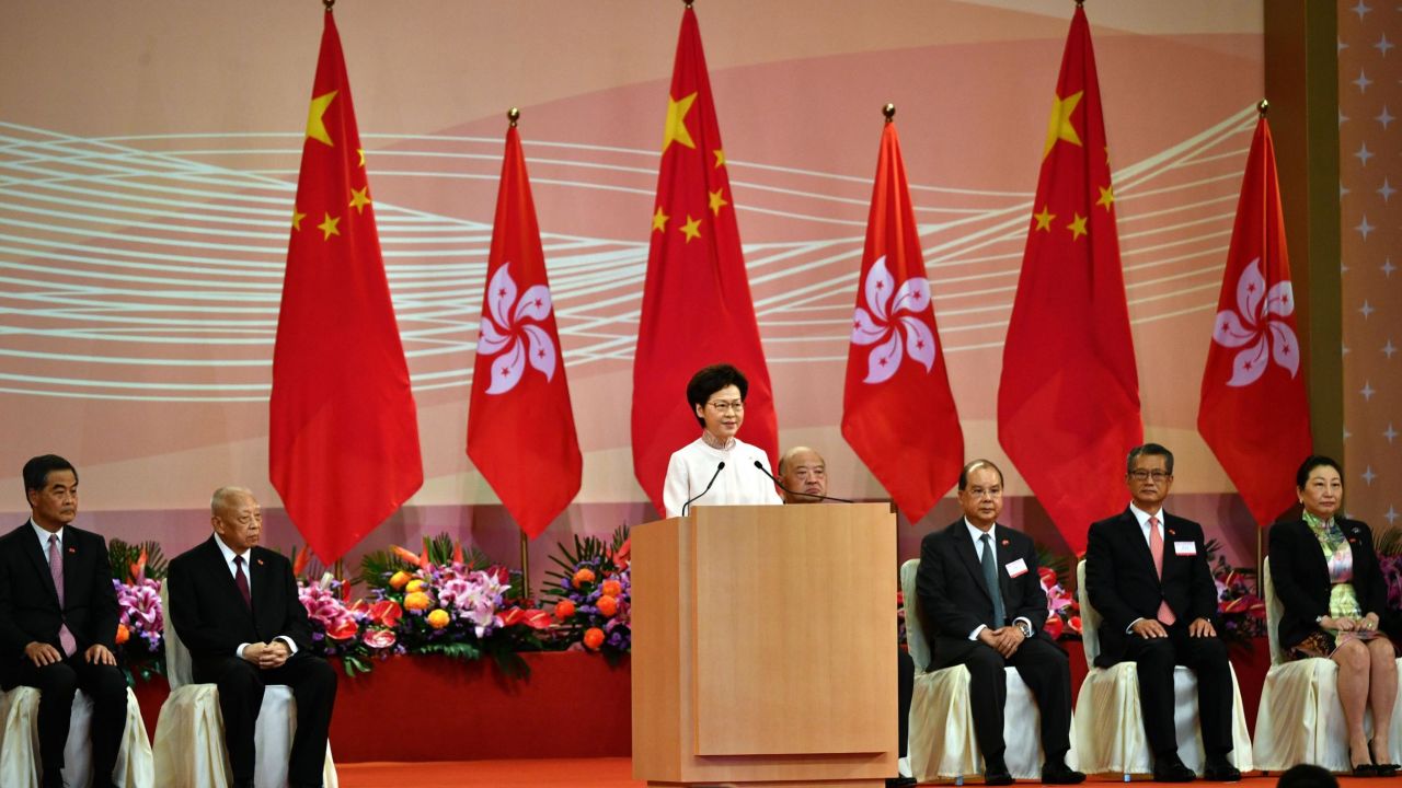 Hong Kong's Chief Executive Carrie Lam (C) speaks to guests following a flag-raising ceremony to mark China's National Day celebrations early morning in Hong Kong on July 1, 2020.
