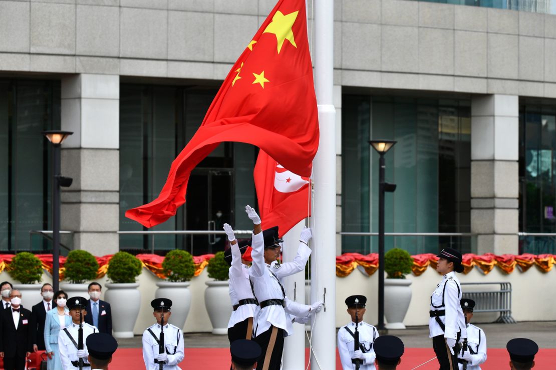 The Chinese (front) and Hong Kong flags are released during a flag-raising ceremony to mark China's National Day celebrations early morning in Hong Kong on July 1, 2020.