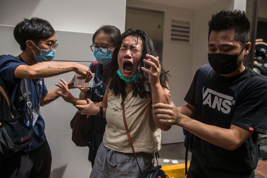 A woman reacts to pepper spray as police were clearing protesters in Hong Kong on Wednesday, July 1.