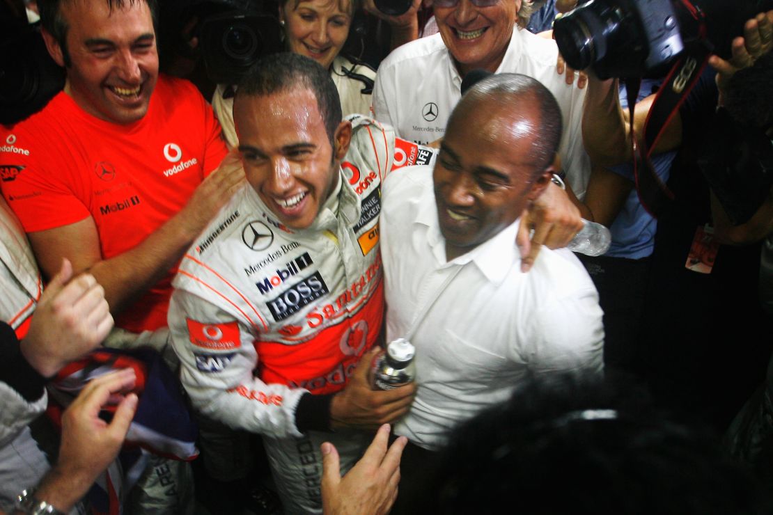 Hamilton celebrates with his father Anthony Hamilton (R) in his team garage following the Brazilian Grand Prix at the Interlagos Circuit on November 2, 2008 in Sao Paulo, Brazil.