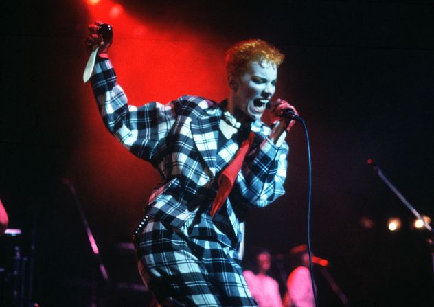 Singer Annie Lennox of Eurythmics performing onstage in London, 1983. She often wore big, baggy suits to concert with a flash dyed orange hair. 