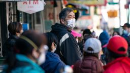 A man wearing a protective mask waits in line at a meat market in the Chinatown neighborhood of New York, U.S., on Monday, April 6, 2020. New York Governor Andrew Cuomo said deaths from the coronavirus pandemic were showing signs of hitting a plateau in the state that has become the epicenter of the U.S. outbreak. Photographer: Jeenah Moon/Bloomberg via Getty Images