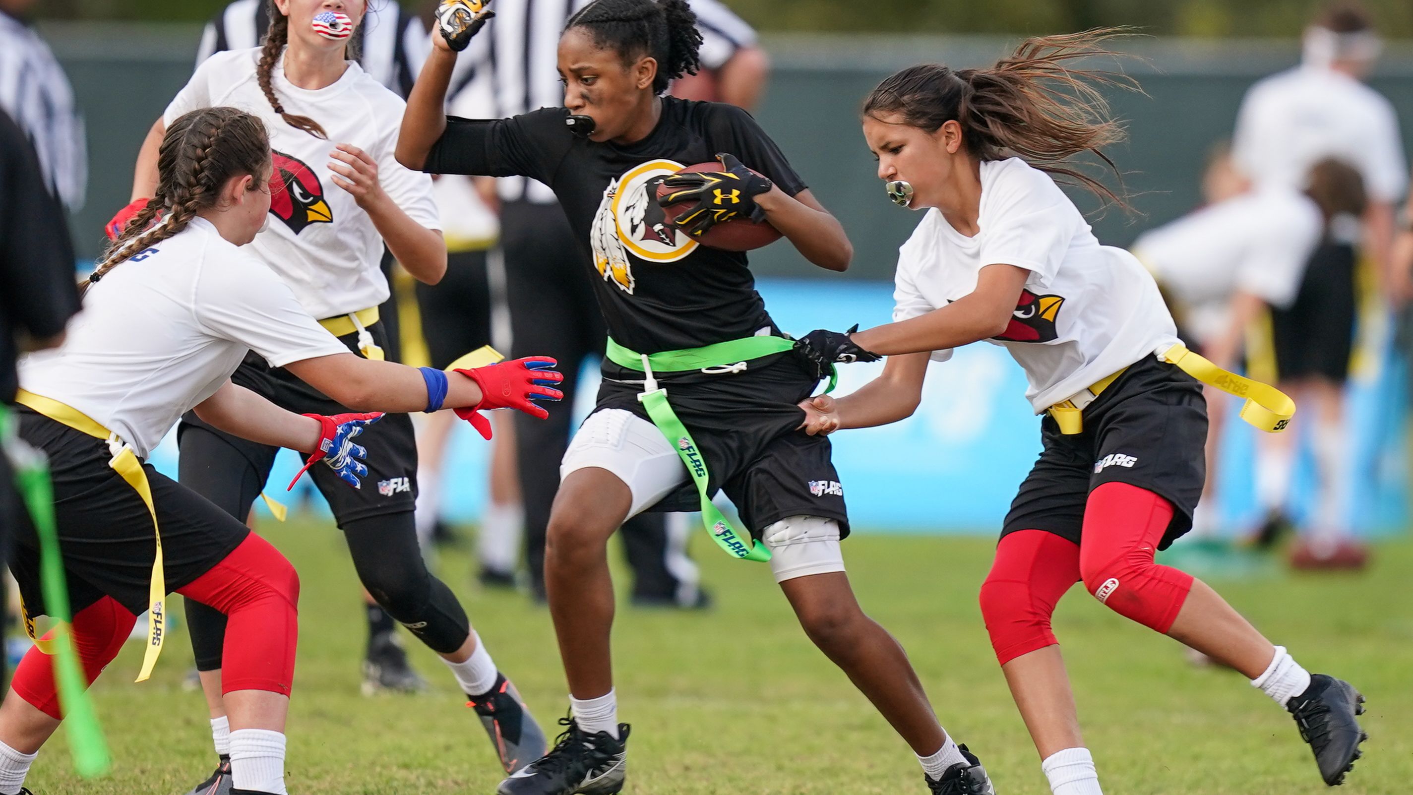 Players participate in the first day of games in the NFL Flag Football Championships.