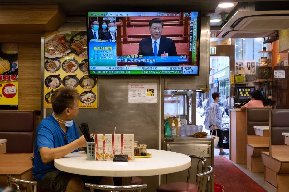 A man at a diner watches Chinese President Xi Jinping on May 28 as Chinese lawmakers approved a proposal for the new security law.