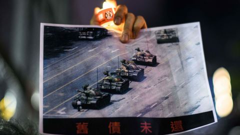 A man holds a poster of the famous 'Tank Man' who stood in front of Chinese military tanks at Tiananmen Square in Beijing in 1989.