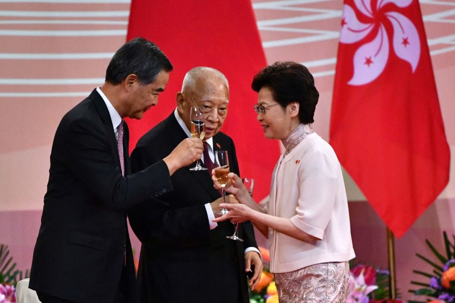 Hong Kong Chief Executive Carrie Lam makes a toast with former chief executives Tung Chee-hwa, center, and Leung Chun-ying following a flag-raising ceremony on July 1. July 1 is the 23rd anniversary of Hong Kong's handover from British rule to China.