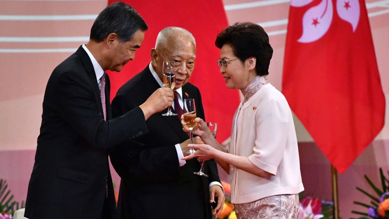 Hong Kong's Chief Executive Carrie Lam (right) makes a toast with former leaders Tung Chee-hwa (center) and Leung Chun-ying (left) following a ceremony to mark the 23rd anniversary of Hong Kong's handover on July 1, 2020.