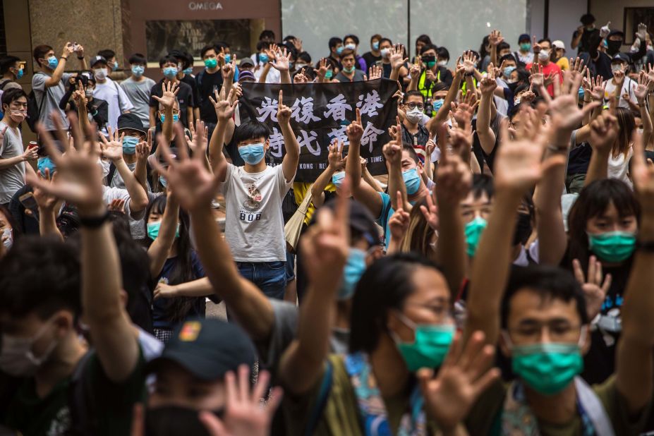 Protesters chant slogans during a rally on July 1. The gesture demands the government to meet their "five demands, not one less."