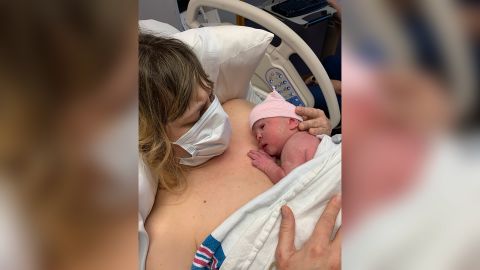 Valeri Hedges holds her newborn daughter Adrienne shortly after she gave birth in May. She had to wear a mask the entire time she was in the hospital because of the coronavirus pandemic.