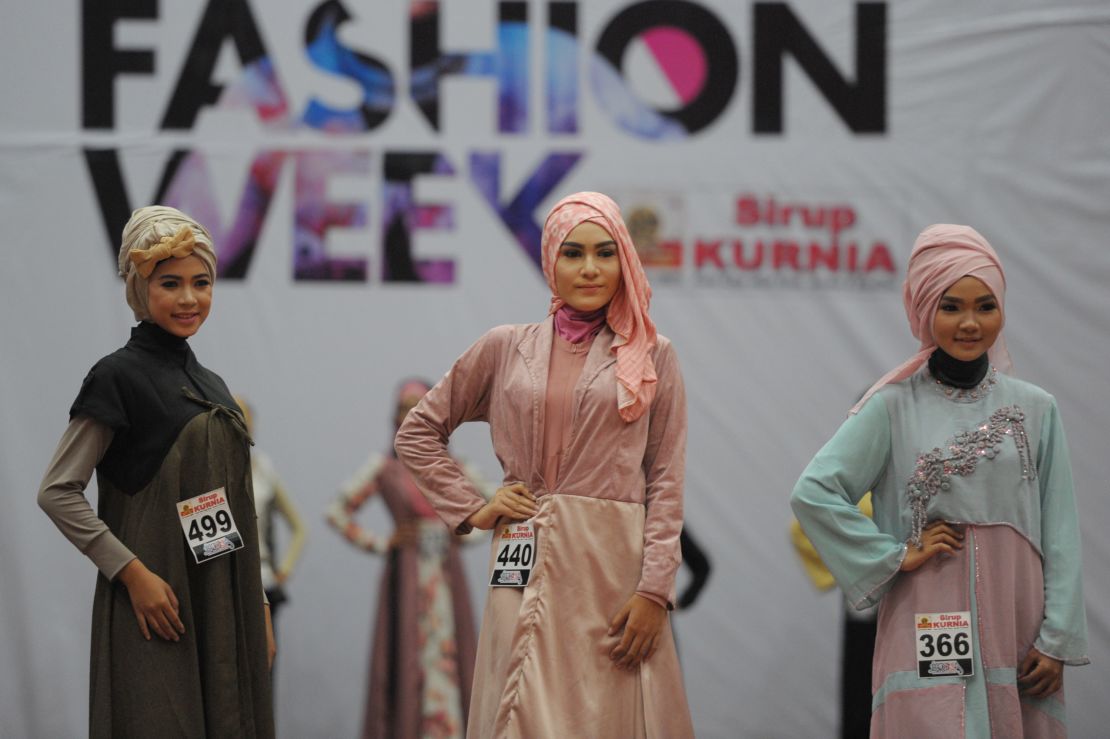 Models in modern hijab parade on the catwalk during Aceh Fashion Week in Banda Aceh.