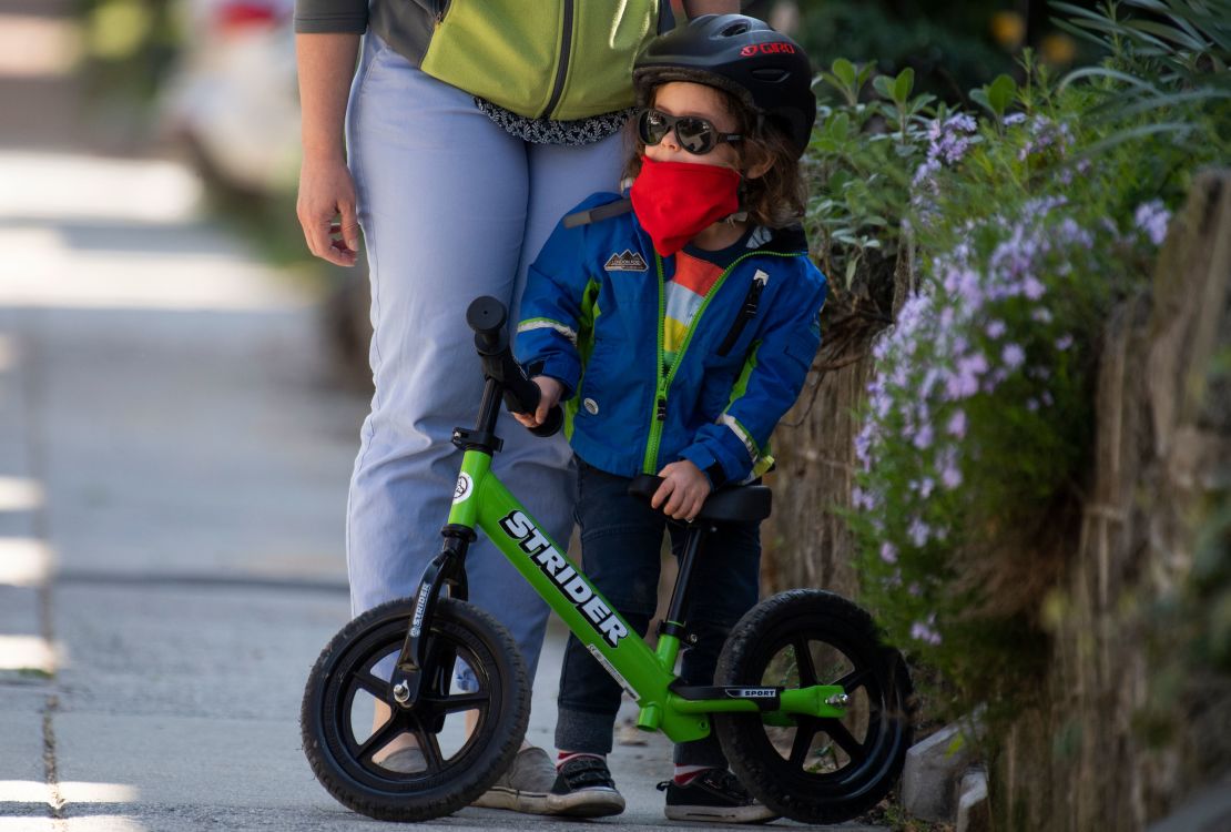 A 3-year-old wraps up a bike ride on Randolph Place NW, in the Bloomingdale neighborhood during the coronavirus outbreak on Monday, April 6, 2020.