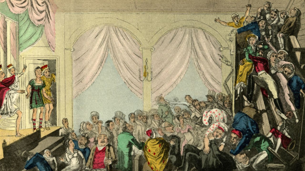 A riotious audience in the balcony during the performance of a play in the early 19th century.