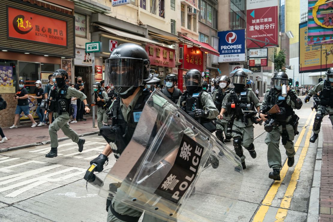 Riot police toward pedestrians during a demonstration on July 1, 2020 in Hong Kong.