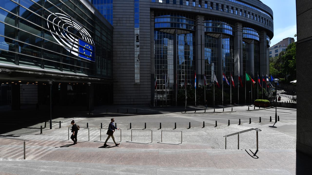 Pedestrians pass the European Parliament's Paul-Henri Spaak building in Brussels, Belgium, on Wednesday, May 27, 2020.