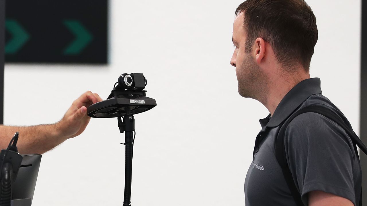 A US Customs and Border Protection officer uses facial recognition technology at Miami International Airport in 2018.