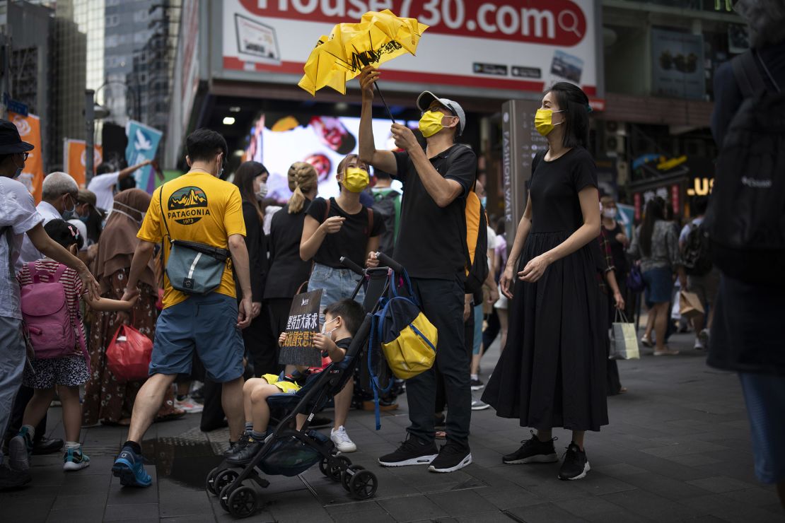 A family in Causeway Bay is seen with signs and yellow paraphernalia, the color of the pro-democracy movement.