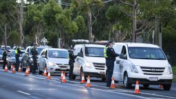 Police check drivers at a roadblock in suburban Melbourne, Australia, on Thursday, July 2, 2020. 