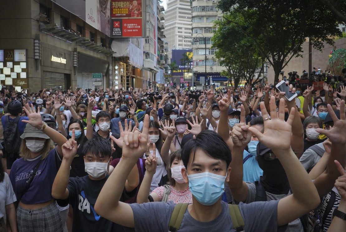 Protesters hold five fingers up in Hong Kong to signal their five demands against the new national security law on July 1, 2020. 