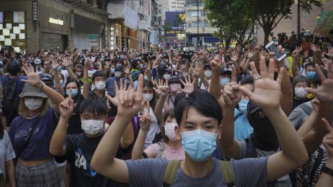 Protesters hold five fingers up in Hong Kong to signal their five demands against the new national security law on July 1, 2020.
