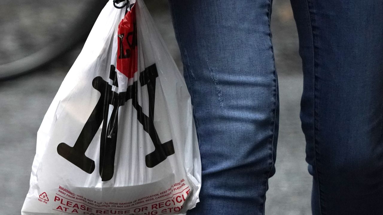 A person with their lunch in a plastic bag walks in midtown in New York in February 2020.