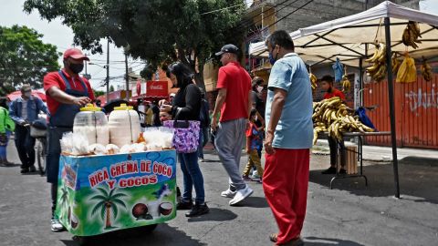 People are seen at a popular street market known locally as a tianguis in  Mexico City on July 2, 2020 as the country authorized the reopening of restaurants, shops, street markets and sport complexes. 