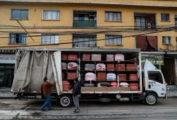 Bergut Funeral Services employees deliver coffins to a funeral store in Santiago, Chile, on  June 19, 2020. Coffin production has increased 120%, according to owner Nicolas Bergerie.