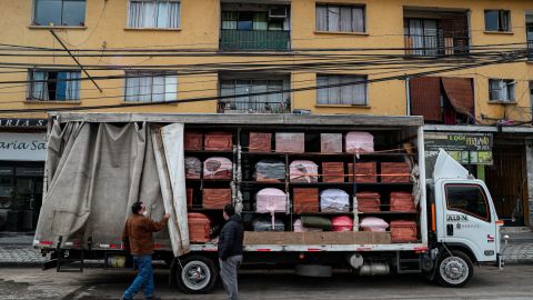 Bergut Funeral Services employees deliver coffins to a funeral store in Santiago, Chile, on  June 19, 2020. Coffin production has increased 120%, according to owner Nicolas Bergerie.