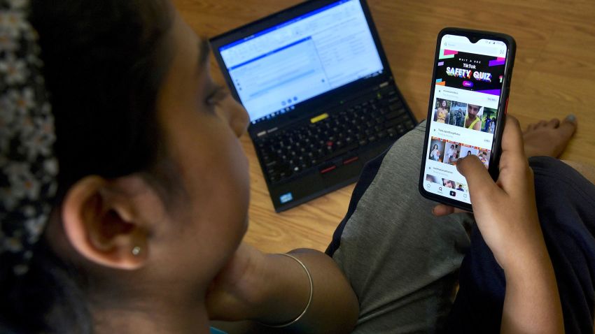 An Indian mobile user browses through the Chinese owned video-sharing 'Tik Tok' app on a smartphone in Bangalore on June 30, 2020.  TikTok on June 30 denied sharing information on Indian users with the Chinese government, after New Delhi banned the wildly popular app citing national security and privacy concerns. "TikTok continues to comply with all data privacy and security requirements under Indian law and have not shared any information of our users in India with any foreign government, including the Chinese Government," said the company, which is owned by China's ByteDance. (Photo by Manjunath Kiran / AFP) (Photo by MANJUNATH KIRAN/AFP via Getty Images)